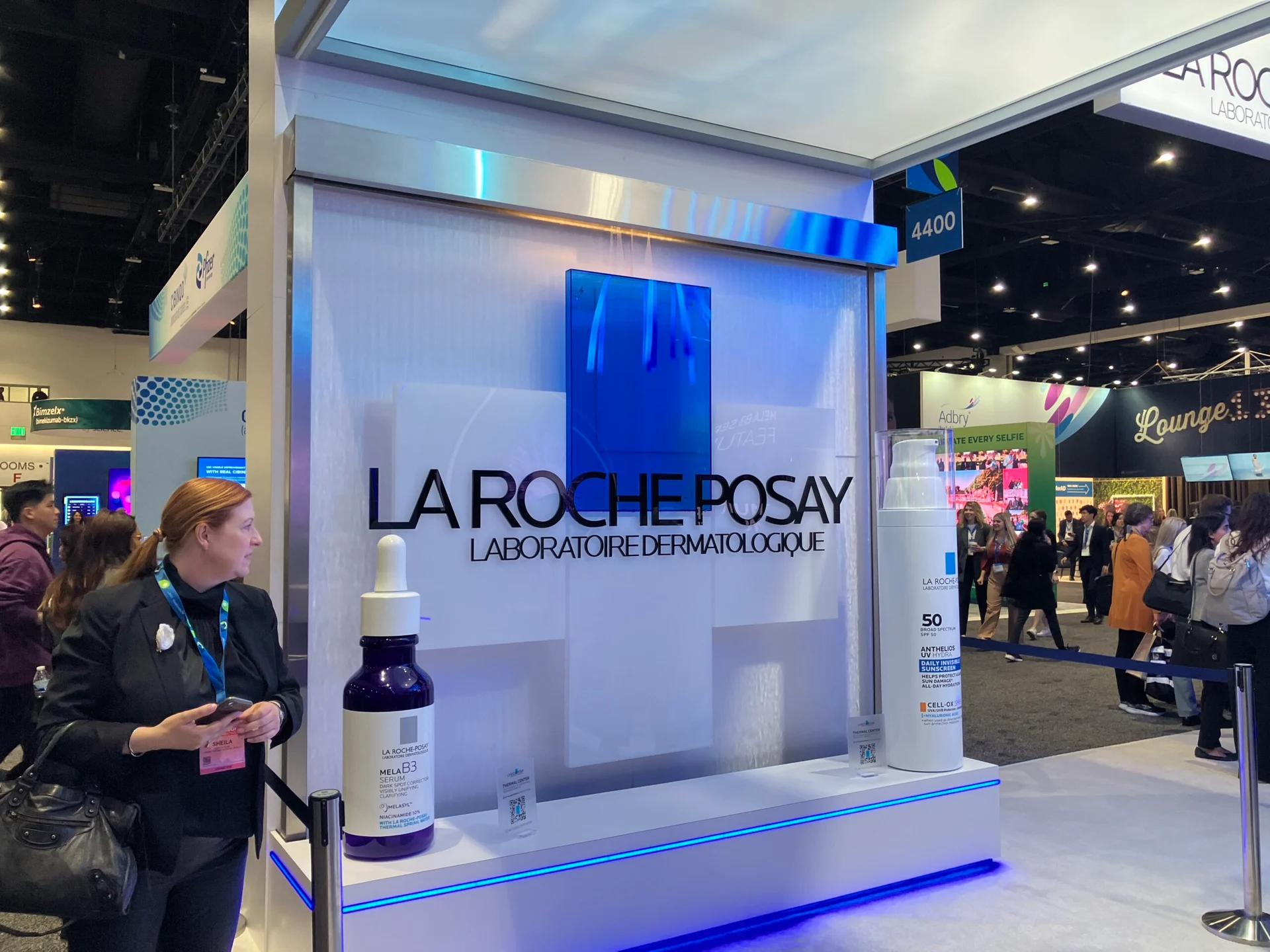 Glass water wall with logo for loreal tradeshow exhibit booth at san diego convention center scaled
